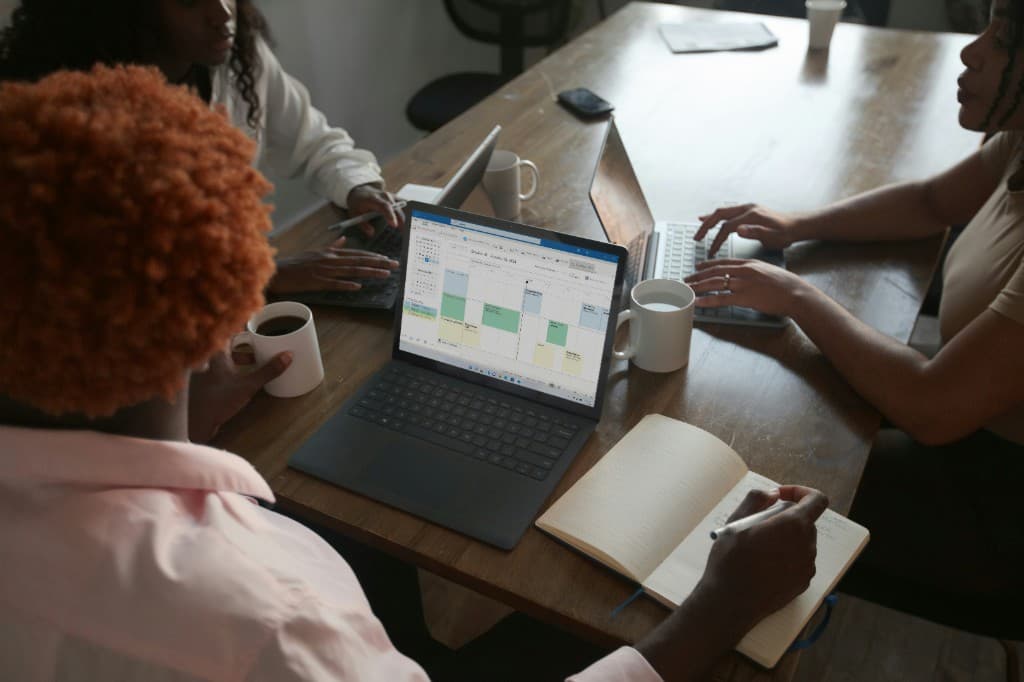 Professionals collaborating at a shared workspace